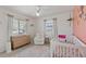 Light-filled Bedroom with charming decor, a plush rug, and cozy seating area at 5264 Albion Rd, Venice, FL 34293