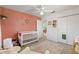 Cozy Bedroom with floral accents, a white crib, and a decorative salmon-colored wall at 5264 Albion Rd, Venice, FL 34293