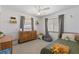 Bright bedroom with neutral carpet, gray curtains, ceiling fan, and cute decor at 5264 Albion Rd, Venice, FL 34293
