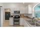 Bright kitchen features white cabinets, stainless steel appliances, and a double oven at 5264 Albion Rd, Venice, FL 34293
