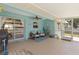Relaxing lanai features a ceiling fan, comfortable seating, and access to the yard at 5264 Albion Rd, Venice, FL 34293
