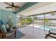 Relaxing lanai features a ceiling fan, comfortable seating, and a view of the pool at 5264 Albion Rd, Venice, FL 34293