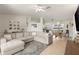 Bright living room boasts an open floor plan, light hardwood flooring, and modern furnishings at 5264 Albion Rd, Venice, FL 34293