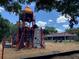Playground area with rocket-themed structure and swings, set against a clear blue sky at 5264 Albion Rd, Venice, FL 34293