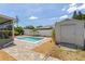Backyard pool with brick paver patio, white shed and lush landscaping at 5264 Albion Rd, Venice, FL 34293