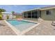 Inviting in-ground pool with brick patio and screened in porch perfect for relaxation at 5264 Albion Rd, Venice, FL 34293