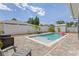Backyard featuring an in-ground pool, brick patio, and white privacy fence at 5264 Albion Rd, Venice, FL 34293