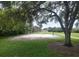 Outdoor sand volleyball court framed by mature trees and green grass at 5264 Albion Rd, Venice, FL 34293