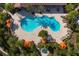 Enjoy an aerial view of this community pool, complete with lounge seating, umbrellas, and cabanas at 5856 Semolino St, Nokomis, FL 34275