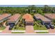 Aerial view of homes with tile roofs, brick driveways, and manicured lawns at 5856 Semolino St, Nokomis, FL 34275