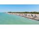 View of a scenic beach, teeming with people, near the community's neighborhood at 5856 Semolino St, Nokomis, FL 34275