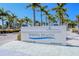 Siesta Beach park sign framed by tall palm trees against a bright blue sky at 5856 Semolino St, Nokomis, FL 34275