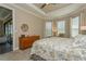 Comfortable bedroom with tray ceilings, carpeted floors, natural light, and access to the screened porch at 5856 Semolino St, Nokomis, FL 34275