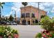 Elegant peach-colored building exterior with awnings, decorative accents, and surrounding landscaping at 5856 Semolino St, Nokomis, FL 34275