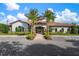 A picturesque clubhouse featuring lush landscaping and ample parking spaces awaits residents at 5856 Semolino St, Nokomis, FL 34275