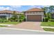 Beautiful home with tile roof and paver driveway; mature landscaping and a two-car garage enhance the curb appeal at 5856 Semolino St, Nokomis, FL 34275