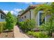 Charming walkway lined with lush plants and lighting leads to the front of this beautifully landscaped home at 5856 Semolino St, Nokomis, FL 34275