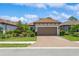 Inviting home with a red tile roof, neat landscaping, and a brick paver driveway leading to a two-car garage at 5856 Semolino St, Nokomis, FL 34275