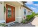 Inviting front door with decorative wreath, sidelights, and a 'Welcome' mat set on a brick paver landing at 5856 Semolino St, Nokomis, FL 34275