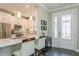 Bright, modern kitchen with white cabinets, stainless steel appliances, granite counters, and pendant lighting at 5856 Semolino St, Nokomis, FL 34275