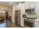 Updated kitchen with stainless steel appliances, granite countertops and backsplash, and white cabinets at 5856 Semolino St, Nokomis, FL 34275