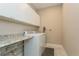 Bright laundry room featuring a washer and dryer, storage cabinets, and a countertop at 5856 Semolino St, Nokomis, FL 34275