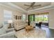 Comfortable living room with neutral decor, ceiling fan, and sliding glass doors to lanai at 5856 Semolino St, Nokomis, FL 34275