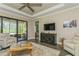 Cozy living room features wood floors, comfortable seating, and access to outdoor patio at 5856 Semolino St, Nokomis, FL 34275