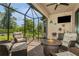Screened-in patio with outdoor furniture and a fire pit at 5856 Semolino St, Nokomis, FL 34275