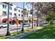 Lively street scene with palm trees lining the sidewalk and businesses along the road at 5856 Semolino St, Nokomis, FL 34275