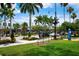 Charming street scene with lush landscaping, palm trees, and a vintage clock at 5856 Semolino St, Nokomis, FL 34275