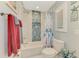 Updated bathroom features white tile, decorative tile accents, and modern fixtures at 5868 Jefferson Rd, Venice, FL 34293