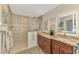 Luxurious bathroom with granite countertops, a tiled shower, and ample vanity space at 5868 Jefferson Rd, Venice, FL 34293