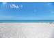 Expansive white sandy beach with clear blue water and scattered beachgoers enjoying the sun at 5868 Jefferson Rd, Venice, FL 34293