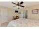 Bedroom featuring a ceiling fan, neutral paint, a TV, and an en-suite bathroom at 5868 Jefferson Rd, Venice, FL 34293