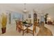 Bright dining room featuring a glass table, bay window with shutters, and stylish chandelier at 5868 Jefferson Rd, Venice, FL 34293