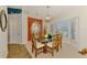 Elegant dining room with a glass table, seating for six, and a decorative mirror at 5868 Jefferson Rd, Venice, FL 34293