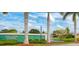A lovely view of the Gulf View Estates entrance sign framed by palms and lush landscaping, enhanced with a tranquil water feature at 5868 Jefferson Rd, Venice, FL 34293