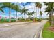 Welcoming entrance to Gulf View Estates featuring lush landscaping, mature palms, and a serene fountain for a pleasant arrival at 5868 Jefferson Rd, Venice, FL 34293