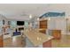 Open kitchen with granite counters, stainless steel appliances, and breakfast bar overlooking the living room at 5868 Jefferson Rd, Venice, FL 34293