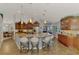 Spacious kitchen featuring granite counters, pendant lighting, stainless appliances, and breakfast bar seating at 5868 Jefferson Rd, Venice, FL 34293