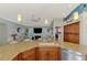 Open kitchen with granite countertops, stainless appliances, and breakfast bar overlooking the living room at 5868 Jefferson Rd, Venice, FL 34293
