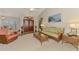 Inviting living room with wicker furniture, light-colored carpet, and a decorative front door at 5868 Jefferson Rd, Venice, FL 34293