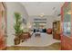 Bright living room features high ceilings, a ceiling fan, and sliding doors leading to the pool area at 5868 Jefferson Rd, Venice, FL 34293