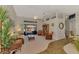 Open-concept living room boasts a vaulted ceiling, ceiling fan, and sliding glass doors to the outdoor area at 5868 Jefferson Rd, Venice, FL 34293
