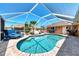 Relaxing screened-in pool area featuring lounge chairs, brick patio, and a refreshing blue pool, perfect for outdoor enjoyment at 5868 Jefferson Rd, Venice, FL 34293