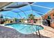 Screened-in pool with clear blue water, a brick paver deck, and comfortable lounge furniture at 5868 Jefferson Rd, Venice, FL 34293