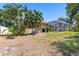 Spacious backyard with a screened-in patio and lush greenery at 622 Pine Ranch East Rd, Osprey, FL 34229