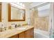 Bathroom with granite countertops, a framed mirror, and a shower-tub combo at 622 Pine Ranch East Rd, Osprey, FL 34229