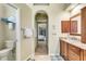 Bathroom featuring marble floors, granite countertops, and a decorative archway leading to the bedroom at 622 Pine Ranch East Rd, Osprey, FL 34229